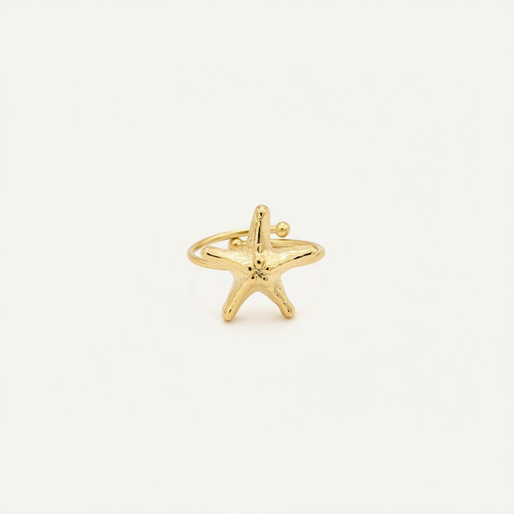 Bague Ipsē Whisper ajustable en acier inoxydable doré avec un motif étoile de mer, résistante à l'eau.
